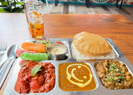 Indian thali with curry, dal, poori and masala chai