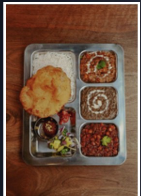 Indian thali with rice, curries and sides